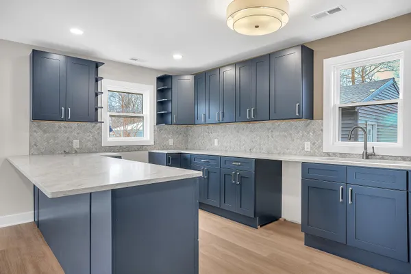 a kitchen with a sink window and cabinets