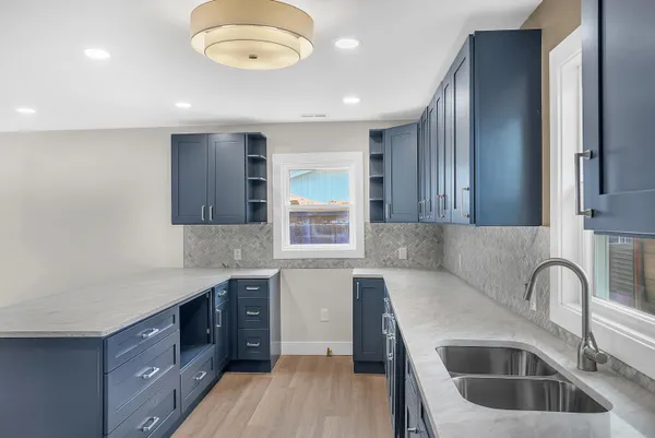 a kitchen with a sink cabinets and window