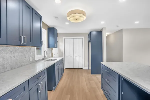 a kitchen with a sink and a refrigerator