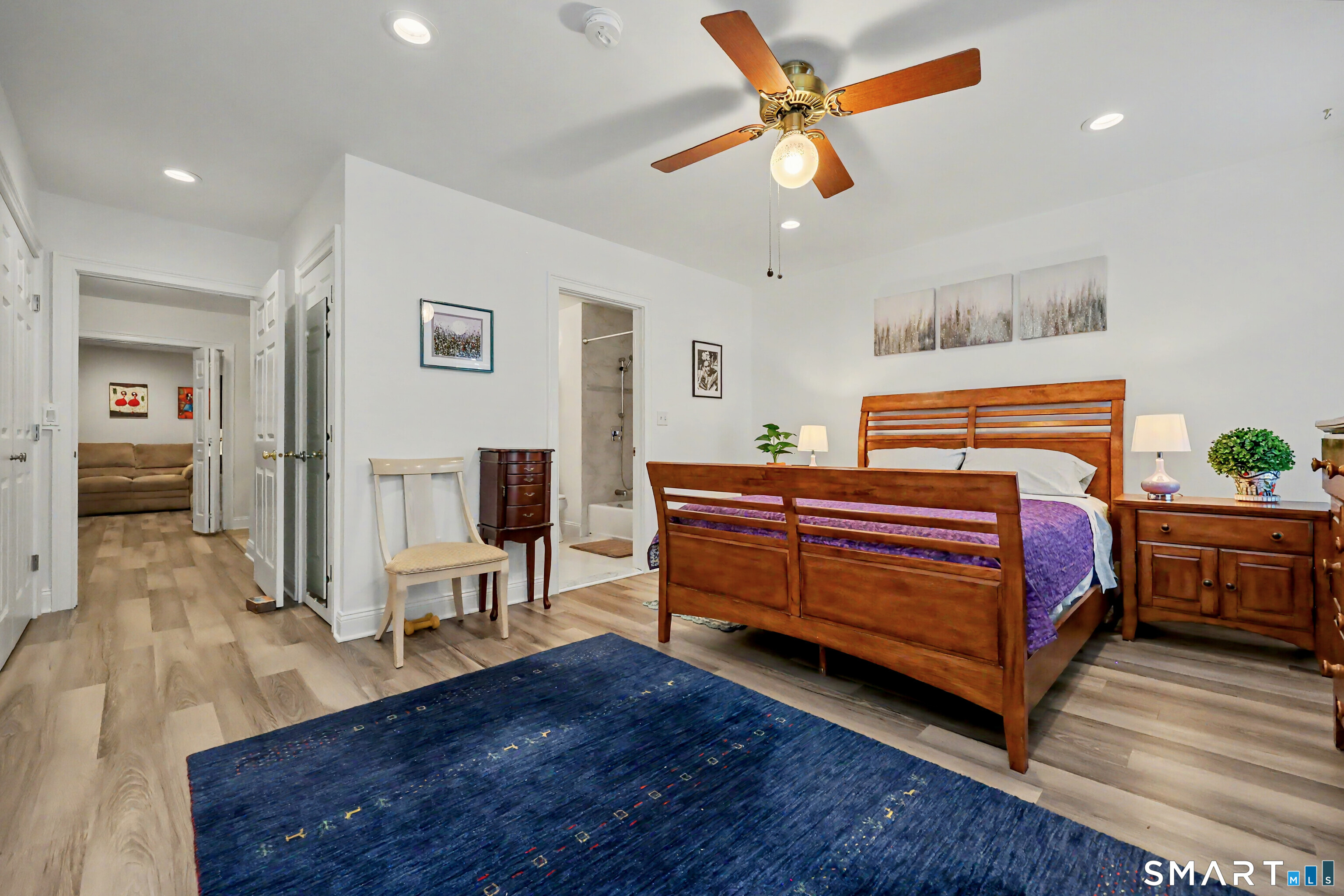 70 Fawn Ridge Lane, Unit 70 Norwalk, CT 06851 - Photo 15 of 36 a bedroom with a bed and a chandelier