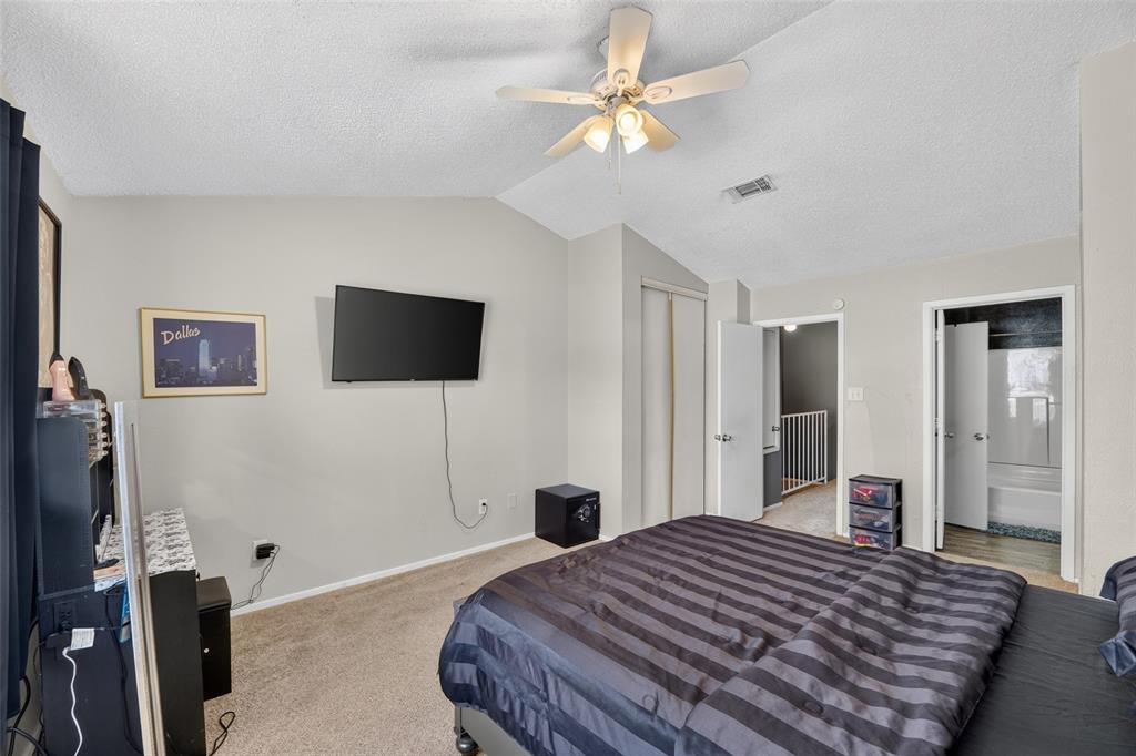 10500 Lake June Road, Unit L07 Dallas, TX 75217 - Photo 14 of 14 Angled ceiling with a built-in ceiling fan, light-toned wall paint, and plush carpet flooring