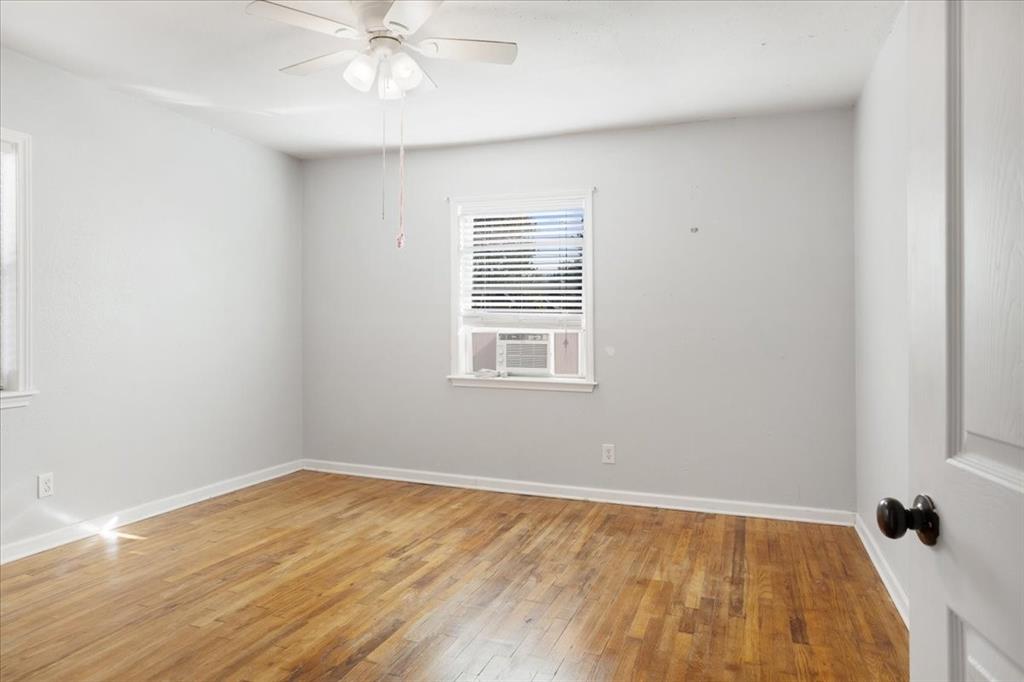 203 South Carter Street Whitewright, TX 75491 - Photo 5 of 18 Bedroom featuring light wood-type flooring and ceiling fan