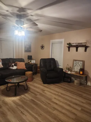 a living room with furniture and a wooden floor