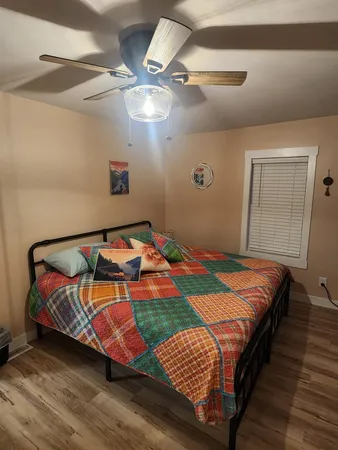 a bed sitting in a bedroom next to a window