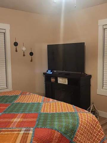 a bed sitting in a bedroom next to a window