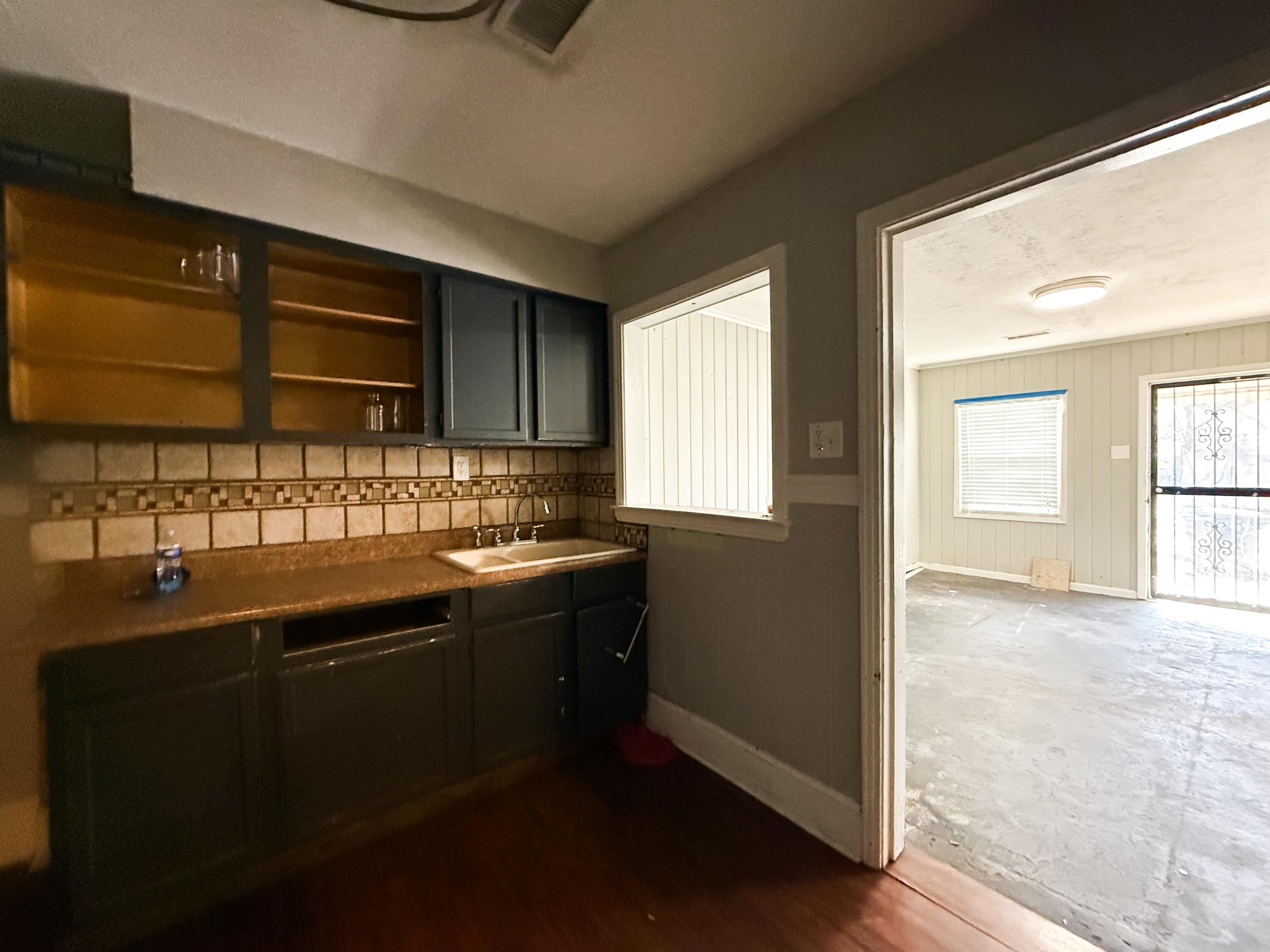1027 Waring Road Memphis, TN 38122 - Photo 5 of 14 Bar featuring baseboards and open shelves