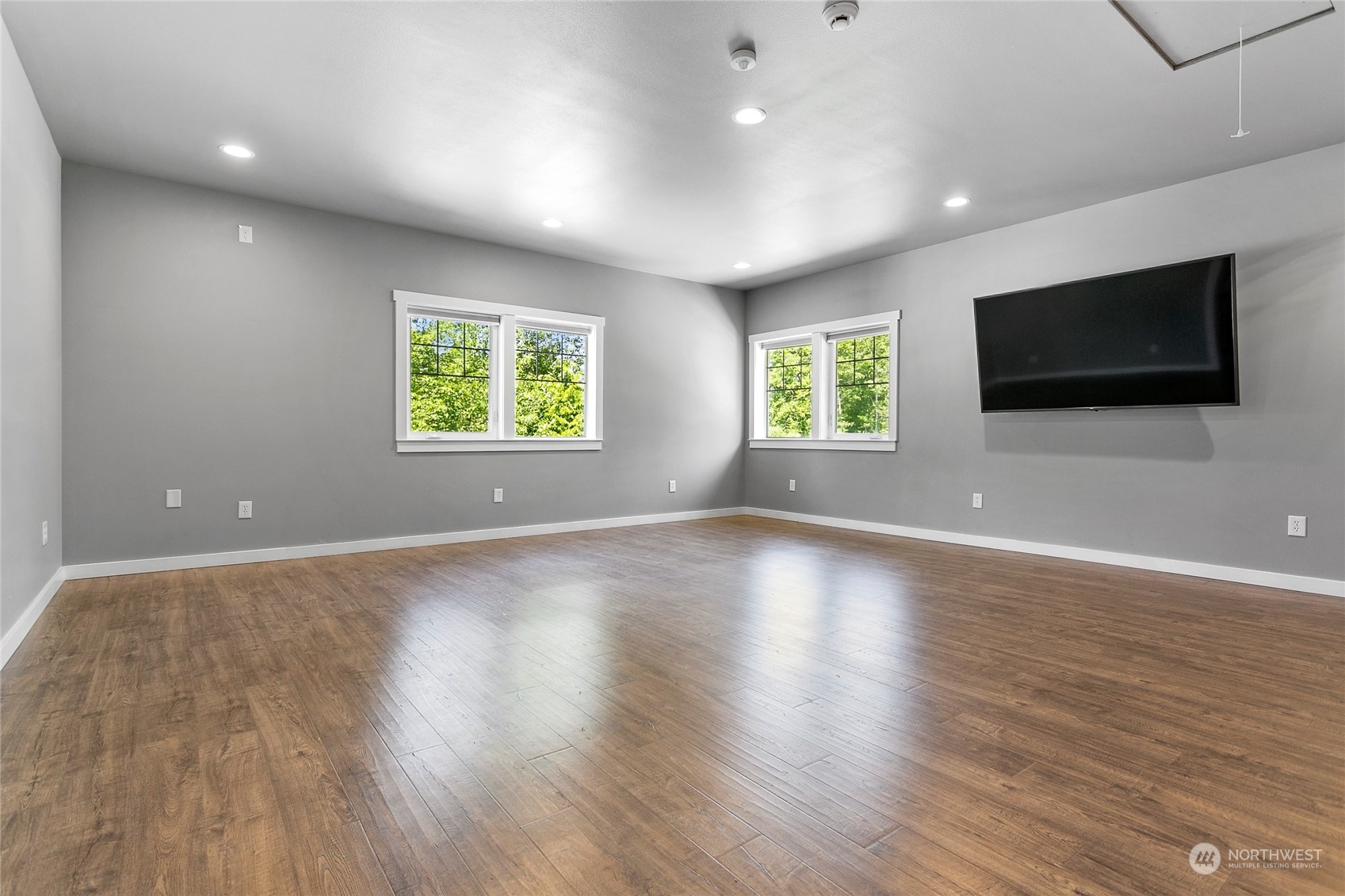 3460 Aldergrove Road Ferndale, WA 98248 - Photo 28 of 39 an empty room with windows tv and wooden floor