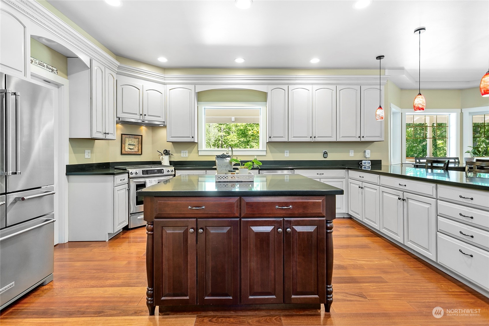 3460 Aldergrove Road Ferndale, WA 98248 - Photo 8 of 39 a kitchen with kitchen island granite countertop wooden floors stainless steel appliances a sink and a window