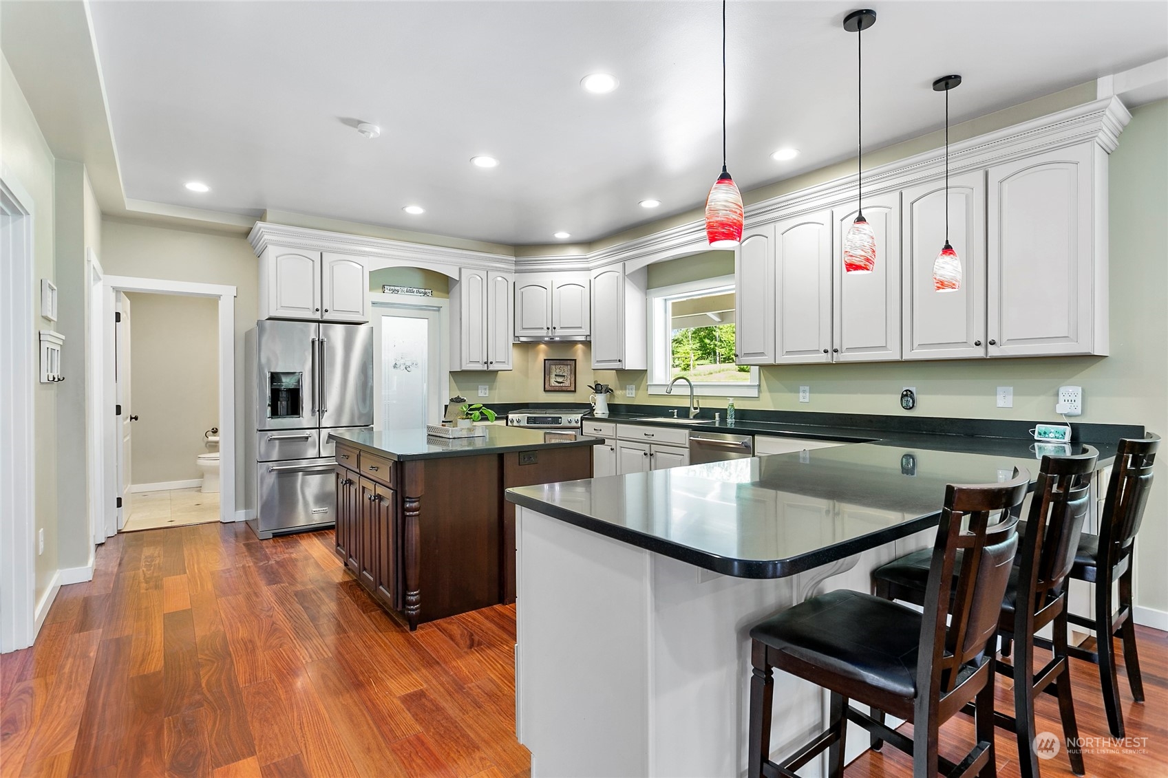 3460 Aldergrove Road Ferndale, WA 98248 - Photo 10 of 39 a kitchen with stainless steel appliances granite countertop a refrigerator a sink dishwasher a stove and white countertops with wooden floor