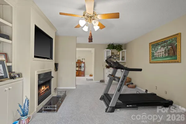 a room with gym equipment and a flat screen tv