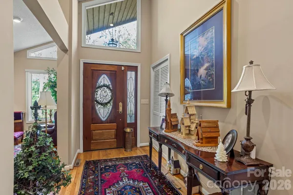 a hallway with a flower pot and a bookshelf