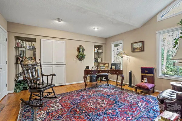 a living room with furniture a rug and a window