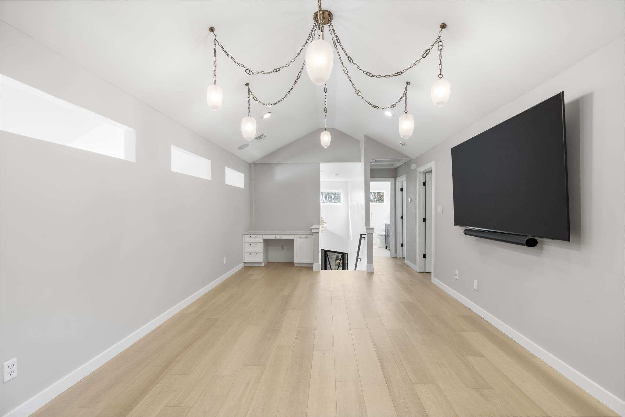 701 Furlong Drive Austin, TX 78746 - Photo 26 of 40 a view of a livingroom with wooden floor and a flat screen tv