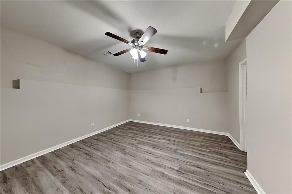 192 Seals Drive Dallas, GA 30157 - Photo 16 of 20 a view of empty room with wooden floor