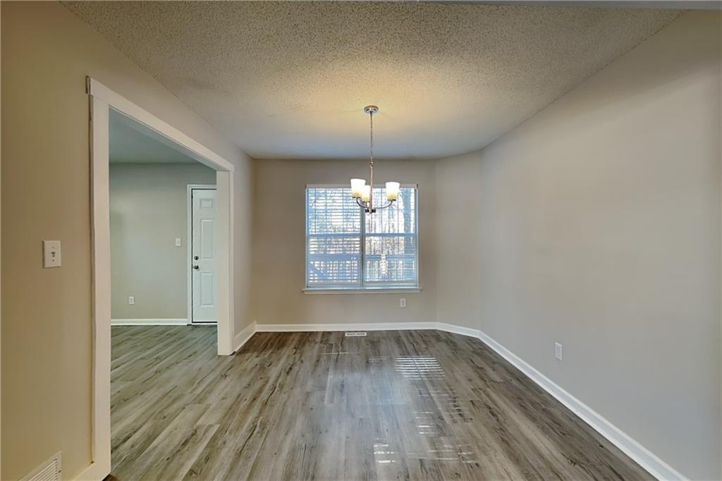 192 Seals Drive Dallas, GA 30157 - Photo 5 of 20 wooden floor in an empty room with a window