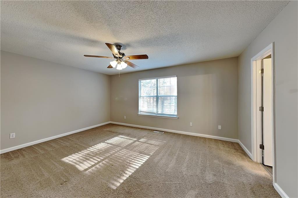 192 Seals Drive Dallas, GA 30157 - Photo 6 of 20 an empty room with windows and fan