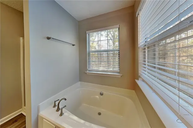 a white bath tub sitting next to a window