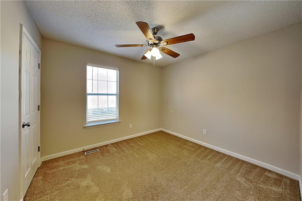 192 Seals Drive Dallas, GA 30157 - Photo 10 of 20 an empty room with a window and a fan