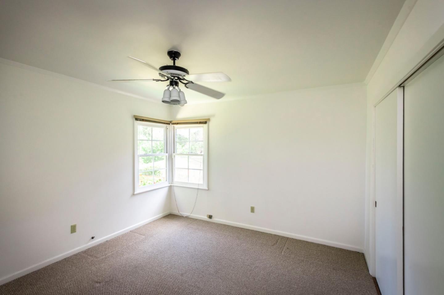 1556 Albemarle Way Burlingame, CA 94010 - Photo 12 of 18 an empty room with a window and a ceiling fan