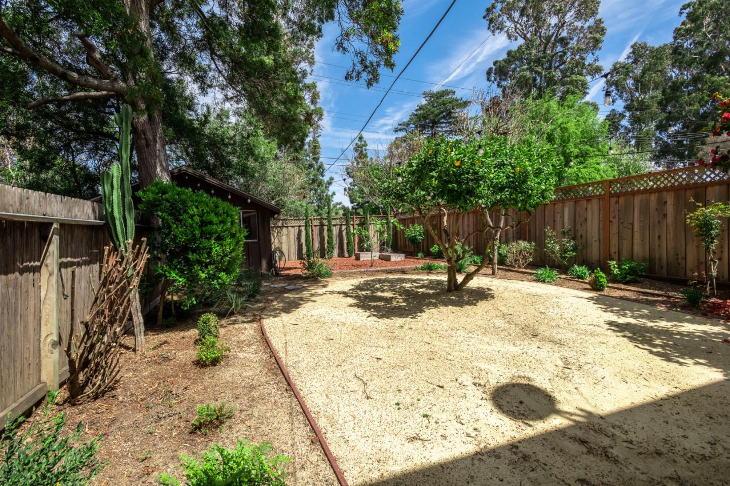 1556 Albemarle Way Burlingame, CA 94010 - Photo 15 of 18 a view of a backyard with large trees and wooden fence