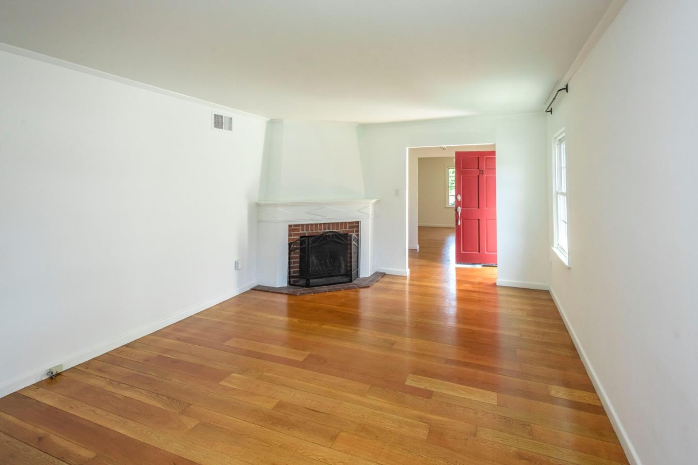 1556 Albemarle Way Burlingame, CA 94010 - Photo 4 of 18 a view of empty room with wooden floor and fireplace