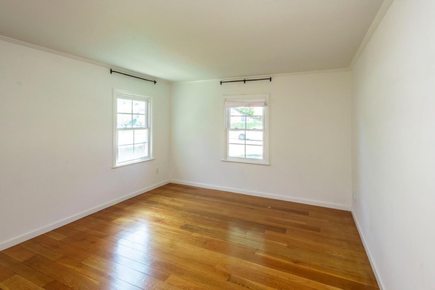 1556 Albemarle Way Burlingame, CA 94010 - Photo 5 of 18 an empty room with wooden floor and windows