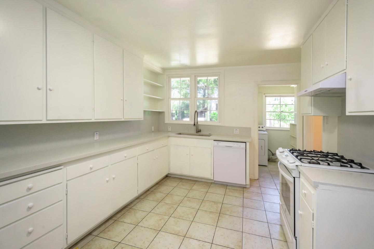 1556 Albemarle Way Burlingame, CA 94010 - Photo 8 of 18 a kitchen with a white cabinets stove and sink