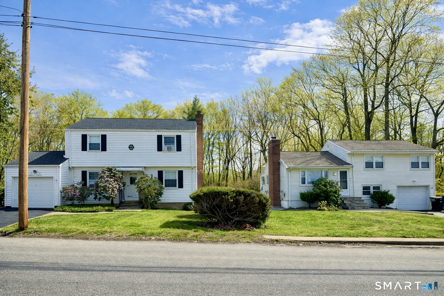 a front view of a house with a yard and potted plants