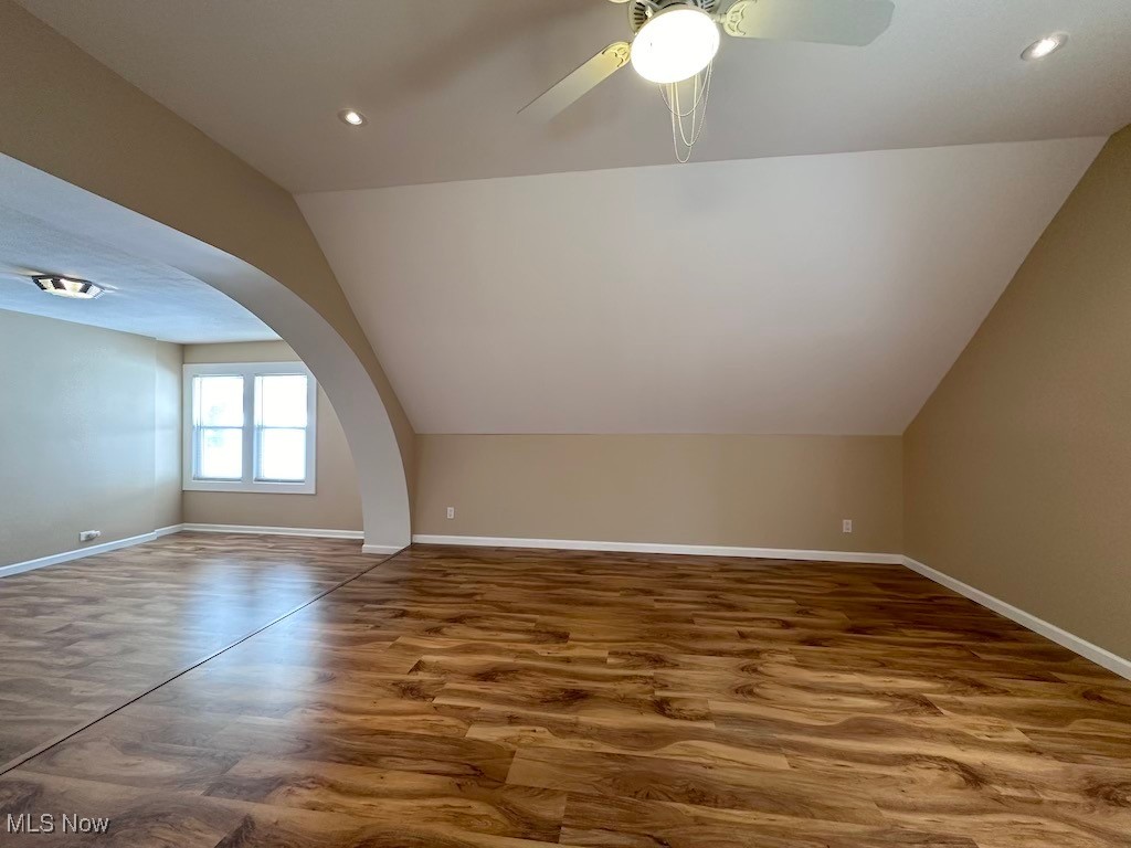 6846 Ottawa Road Cleveland, OH 44105 - Photo 30 of 50 Additional living space with a ceiling fan, wood finished floors, arched walkways, baseboards, and vaulted ceiling