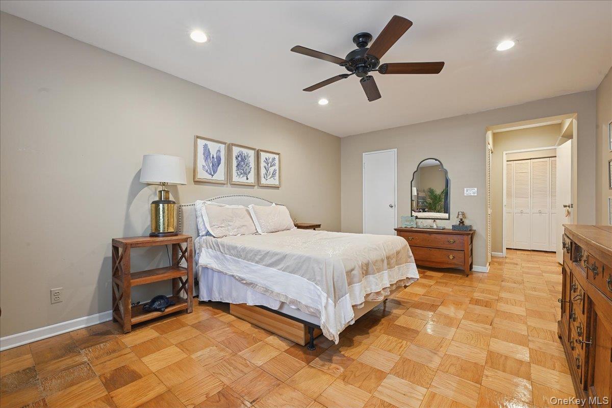 700 Shore Road, Unit 4O Long Beach, NY 11561 - Photo 22 of 42 a bedroom with a large bed and a chandelier