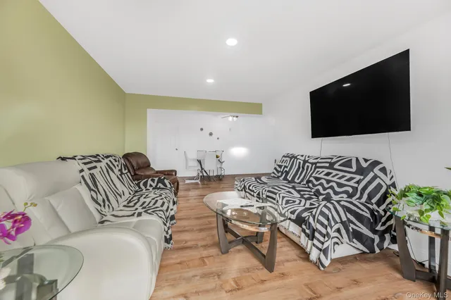 a spacious bedroom with a bed and a flat screen tv