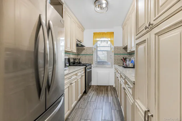 a kitchen with a refrigerator and cabinets