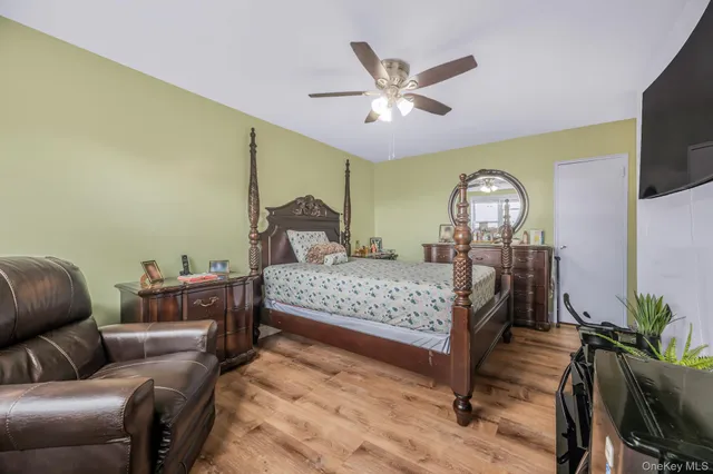 a bedroom with a bed window and flowerpot