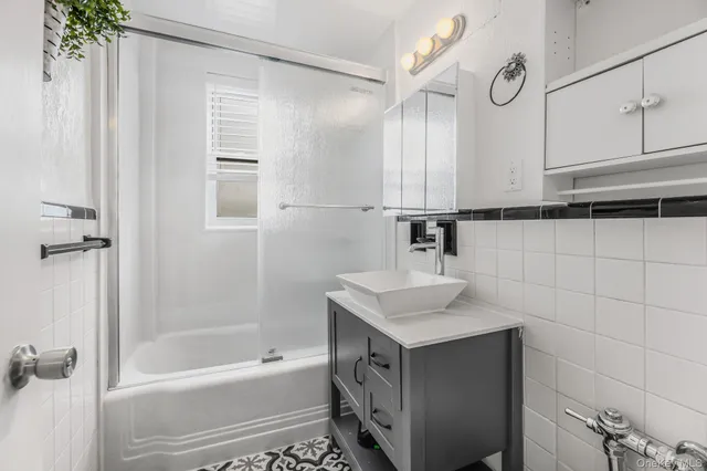 a bathroom with a sink a bathtub and a shower