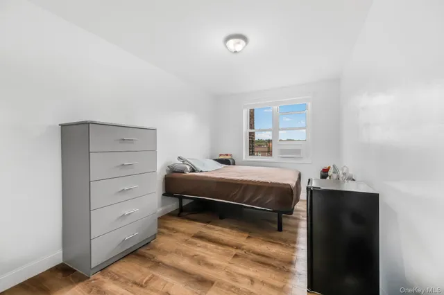 a bedroom with a bed and a dresser