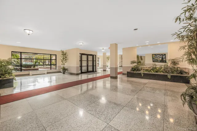 a large white kitchen with a large window and kitchen view