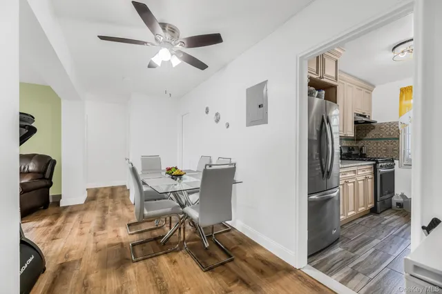 a workspace with wooden floor and a ceiling fan