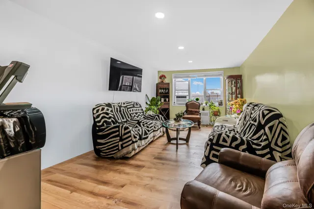 a living room with furniture floor and a flat screen tv