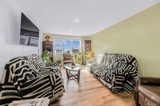 a bedroom with furniture and a floor to ceiling window