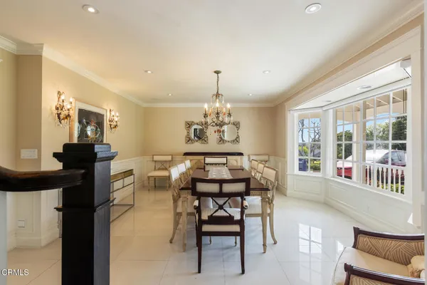 a view of a dining room with furniture and chandelier