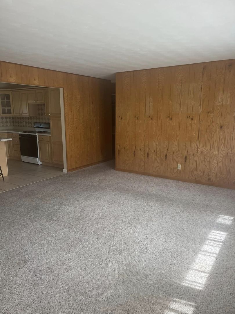 24 Brookwood Drive Normal, IL 61761 - Photo 2 of 12 a view of an empty room with a kitchen