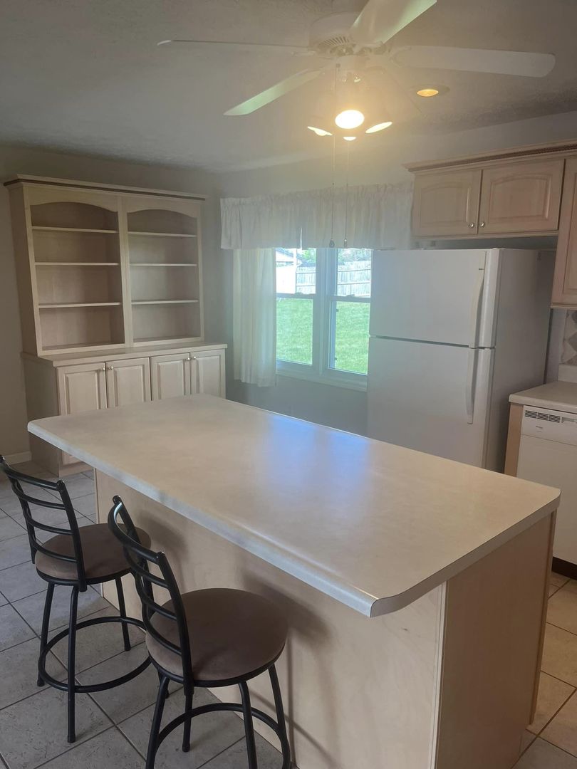 24 Brookwood Drive Normal, IL 61761 - Photo 4 of 12 a kitchen with a table chairs and a refrigerator
