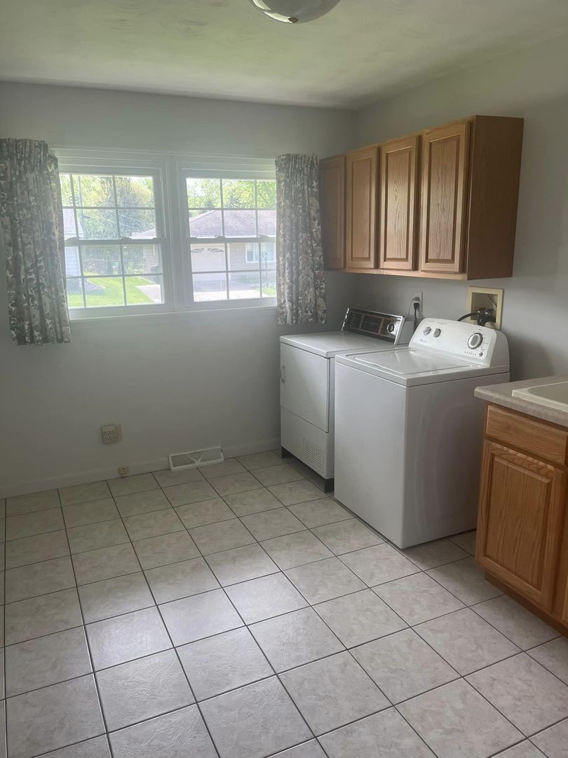 24 Brookwood Drive Normal, IL 61761 - Photo 6 of 12 a utility room with dryer and washer