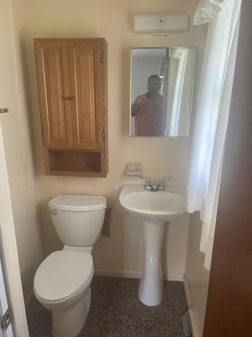 24 Brookwood Drive Normal, IL 61761 - Photo 9 of 12 a bathroom with a toilet sink and mirror