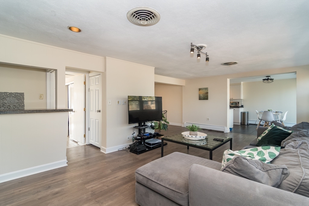 57 Wethersfield Road Natick, MA 01760 - Photo 9 of 28 a living room with furniture and a flat screen tv