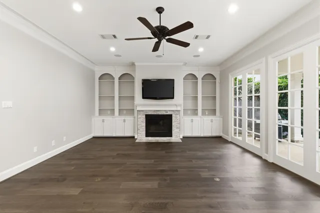 a view of a livingroom with a fireplace a sink and a kitchen space