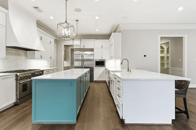a view of an empty room with wooden floor and floor to ceiling windows