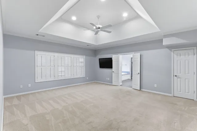 a bathroom with a granite countertop sink two large mirror and a window