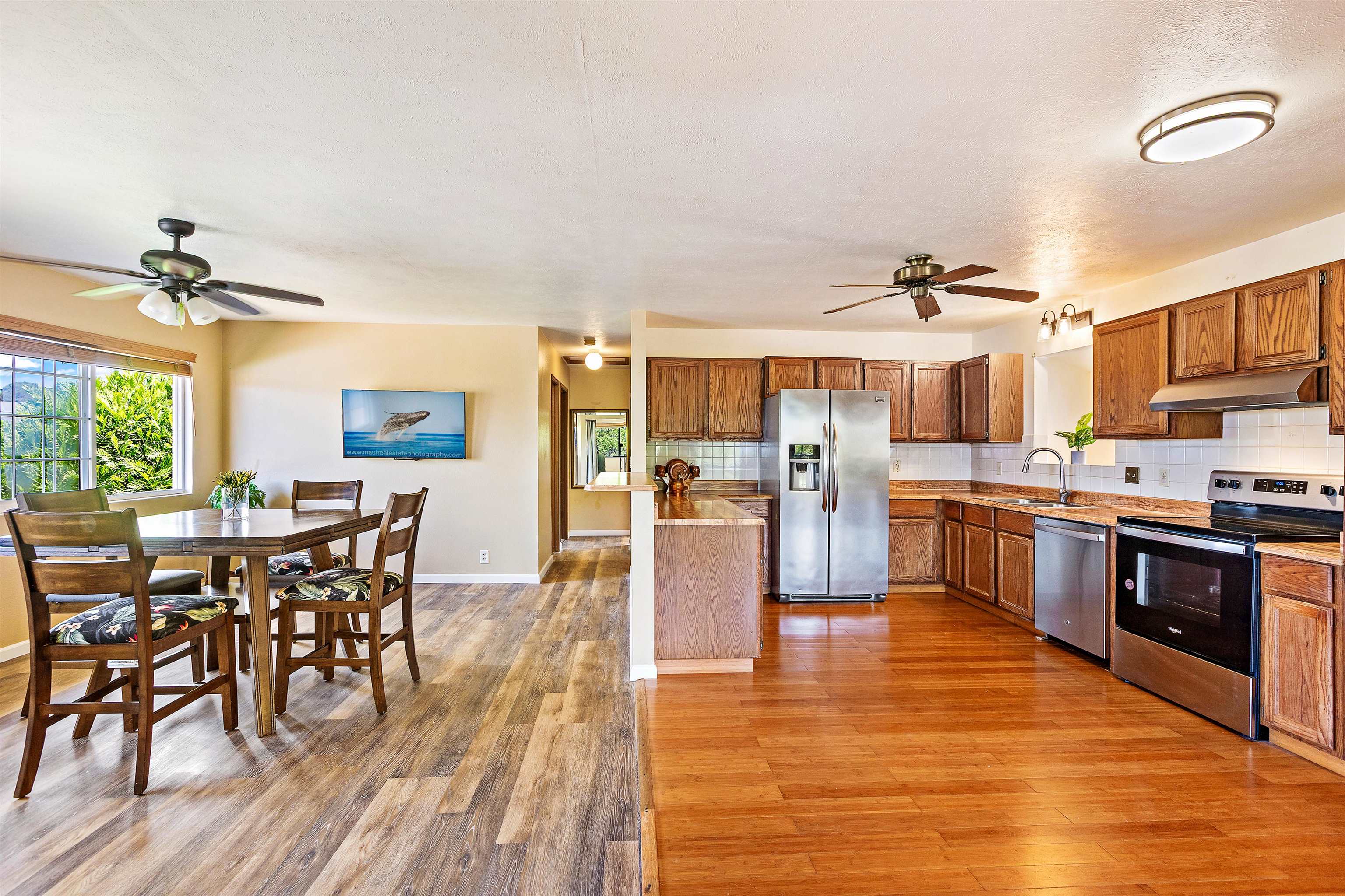 31 Pualu Loop Lahaina, HI 96761 - Photo 1 of 40 a large open kitchen with a table and chairs in it