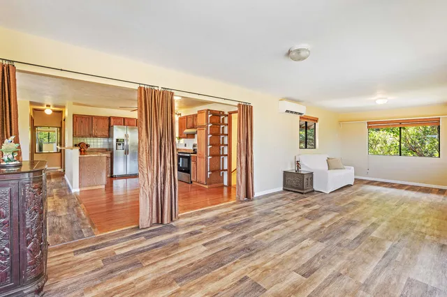 a view of a livingroom with furniture and an entryway